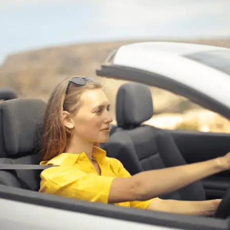 Is Driving Hard For Beginners? a girl in yellow shirt driving the car