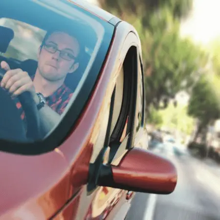 a boy is depressed while driving for the first time